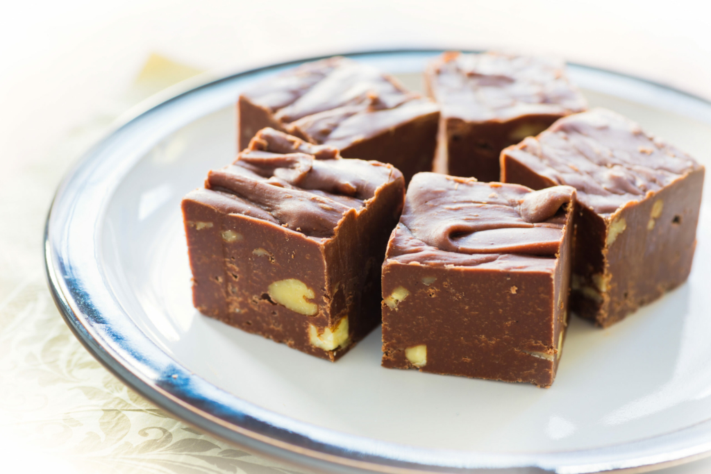 Homemade fudge with nuts and arranged on a small plate.