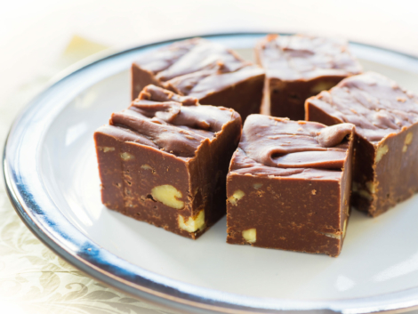 Homemade fudge with nuts and arranged on a small plate.