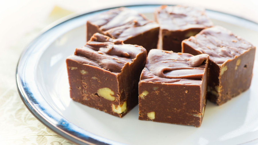 Homemade fudge with nuts and arranged on a small plate.