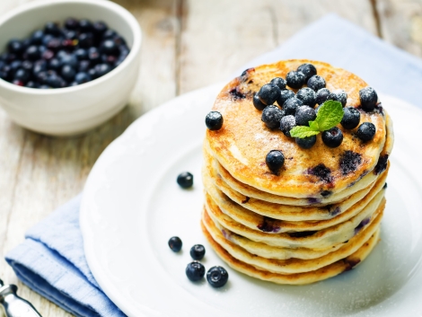 Blueberry Ricotta Pancakes with fresh blueberries and cup of coffee. toning. selective focus