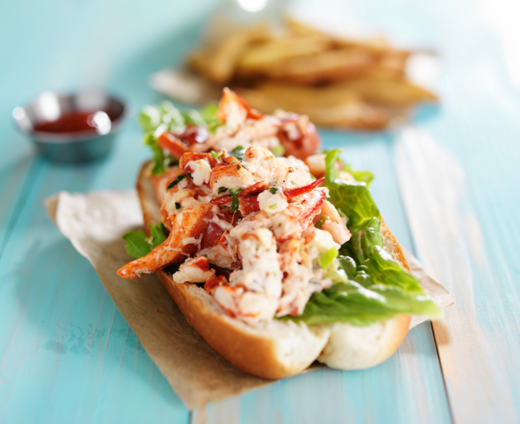 lobster roll on colorful retro painted wooden planks shot close up